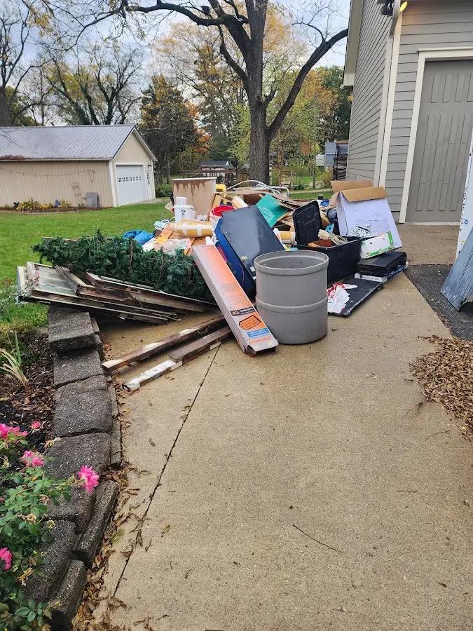 Dumpster being loaded with debris for Estate Cleanout Dumpster Rental in Woodlawn